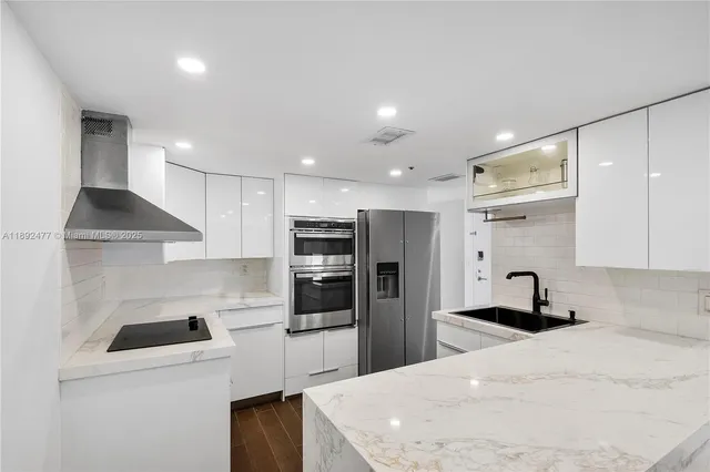 a kitchen with a sink a stove and refrigerator