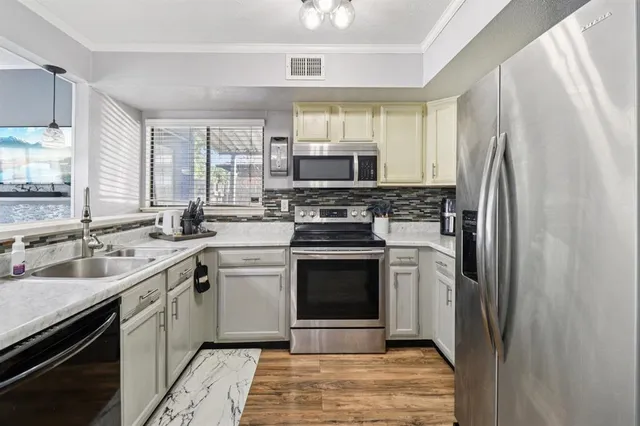 a kitchen with a sink stove and refrigerator