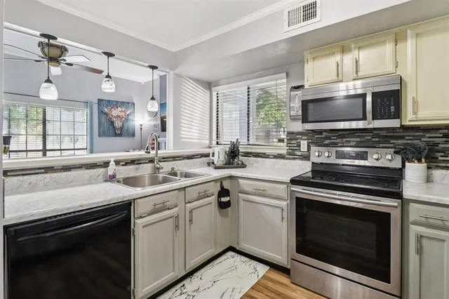 a kitchen with a stove sink and microwave