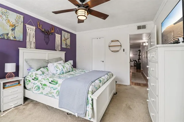 a bed room with a bed and a ceiling fan