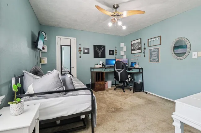 a bedroom with a bed and a desk