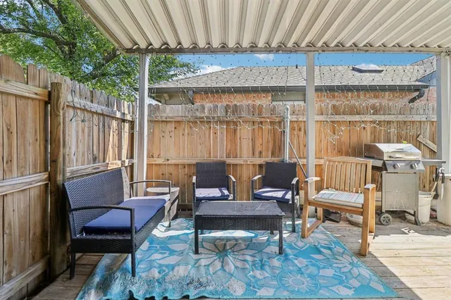 a outdoor living space with furniture and a rug