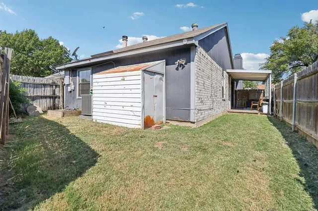 a view of a house with a small yard and a large window