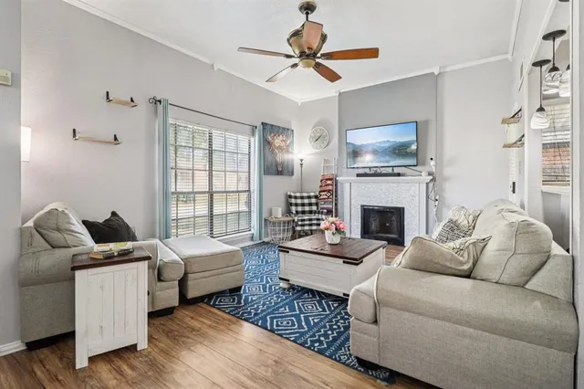 a living room with furniture a fireplace and a flat screen tv