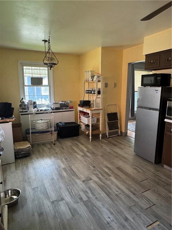 215 Maple Street Kittanning, PA 16201 - Photo 10 of 39 a kitchen with a refrigerator a stove and a dining table with wooden floor