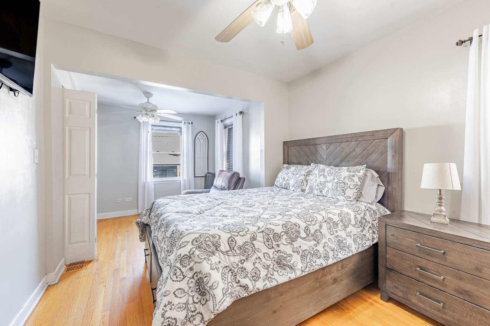 5026 West Addison Street Chicago, IL 60641 - Photo 15 of 34 a bedroom with a large bed and a chandelier