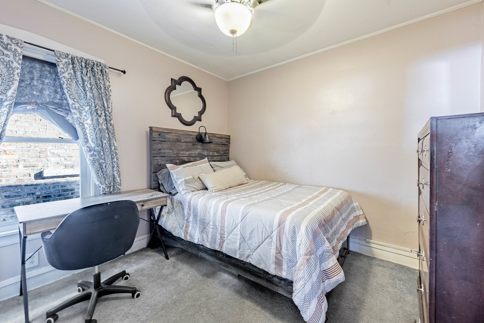 5026 West Addison Street Chicago, IL 60641 - Photo 18 of 34 a bedroom with a bed and a chandelier