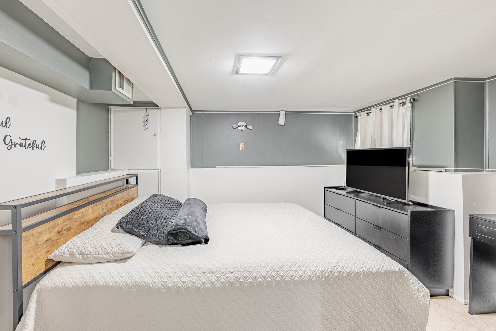 5026 West Addison Street Chicago, IL 60641 - Photo 27 of 34 a bedroom with a bed and a flat screen tv