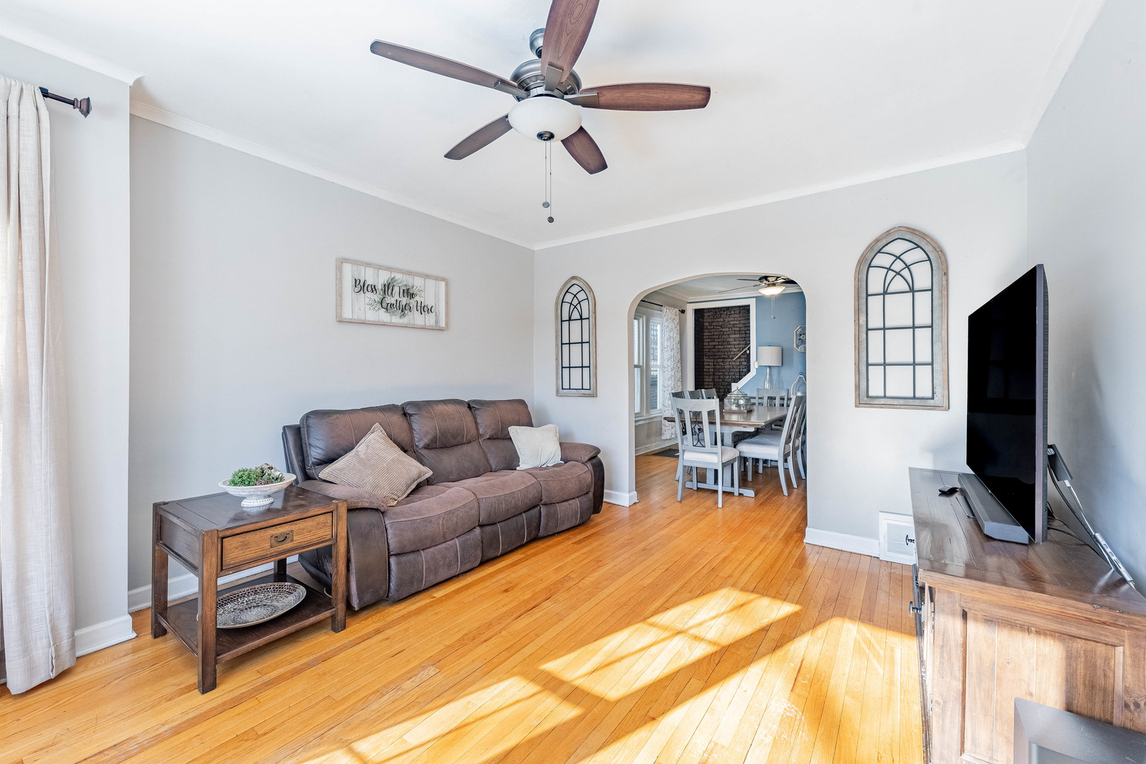 5026 West Addison Street Chicago, IL 60641 - Photo 4 of 34 a living room with furniture a flat screen tv and a large window