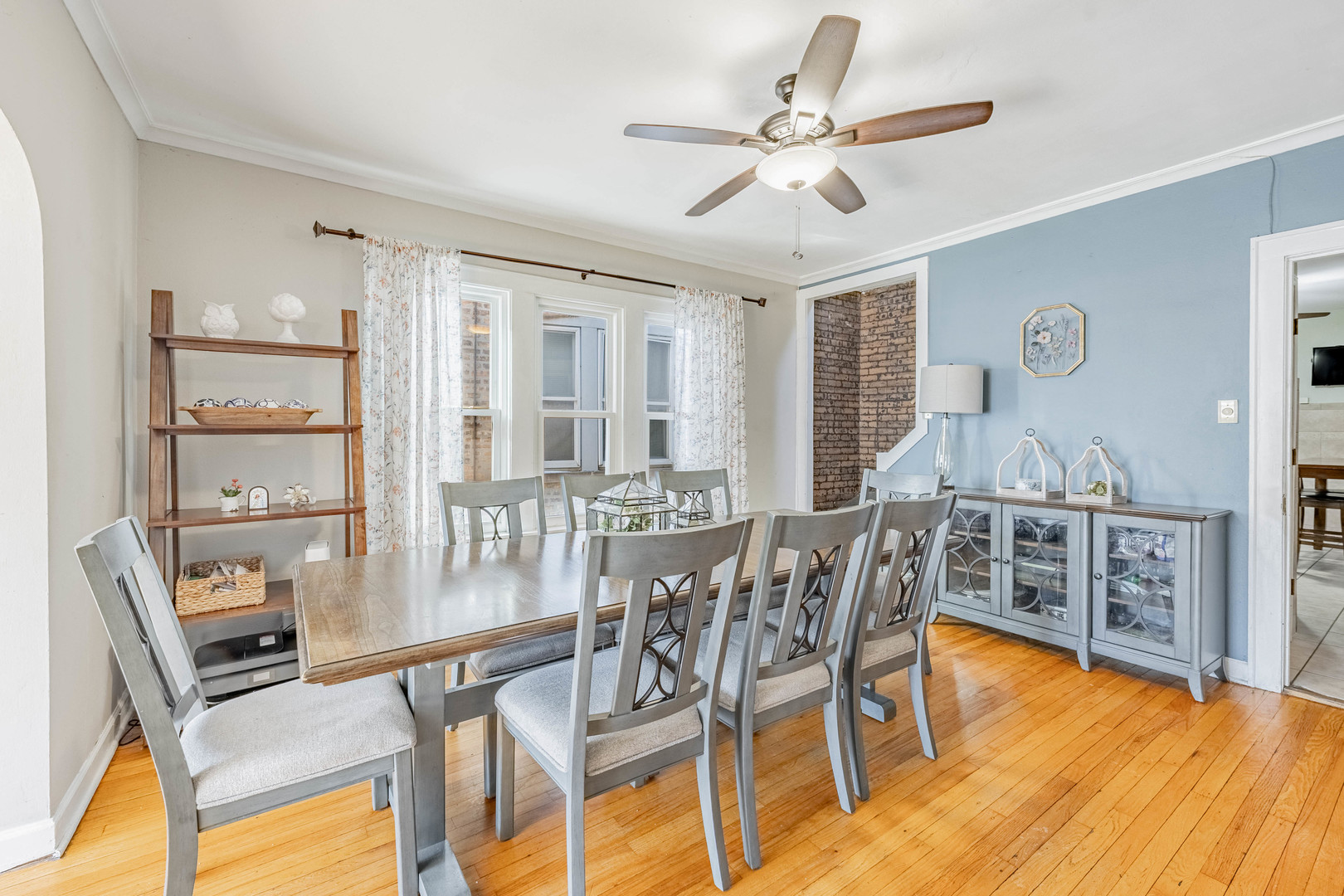 5026 West Addison Street Chicago, IL 60641 - Photo 7 of 34 a dining room with furniture a chandelier and wooden floor