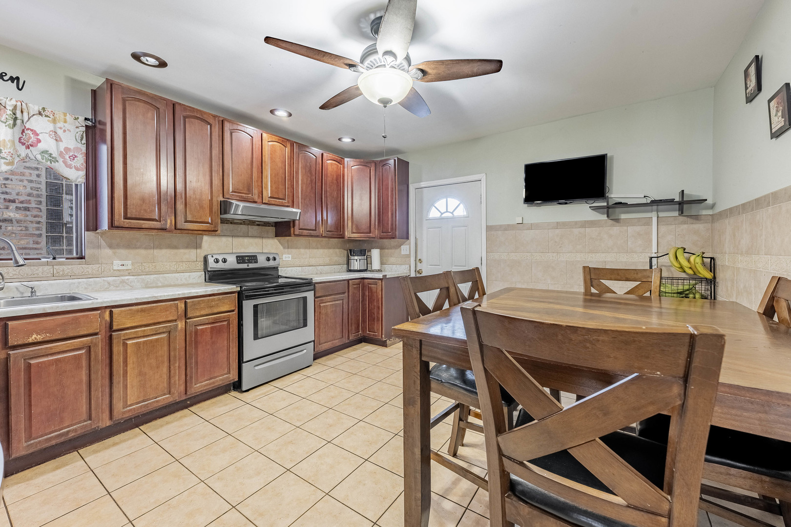 5026 West Addison Street Chicago, IL 60641 - Photo 9 of 34 a kitchen with a dining table and chairs