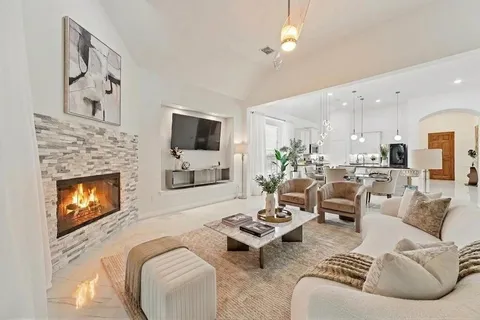 a view of a big house with a big yard and large trees