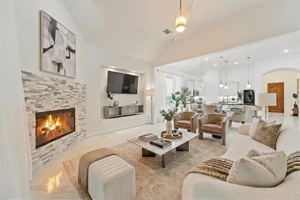 a living room with furniture flat screen tv and a fireplace
