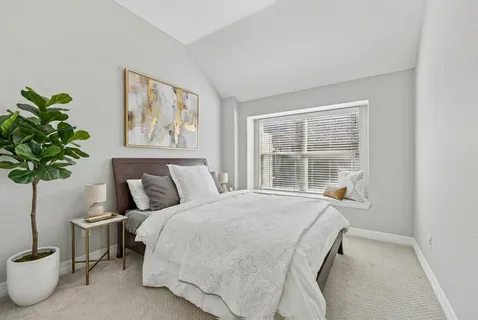 a bedroom with a bed and a chandelier fan