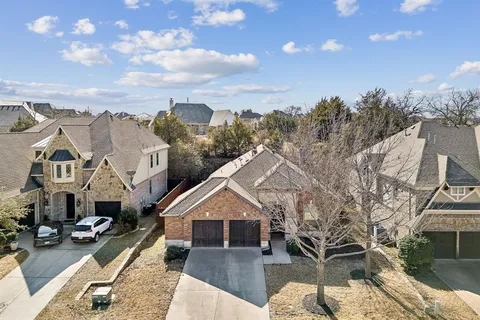 a front view of a house with a garden and yard