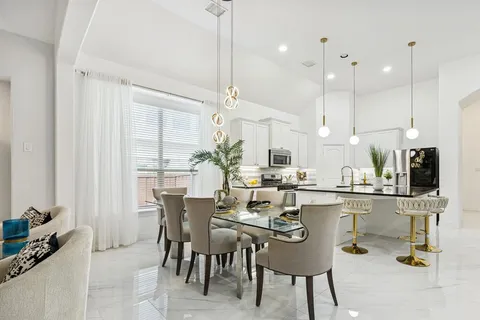 a spacious bedroom with a large bed and a potted plant