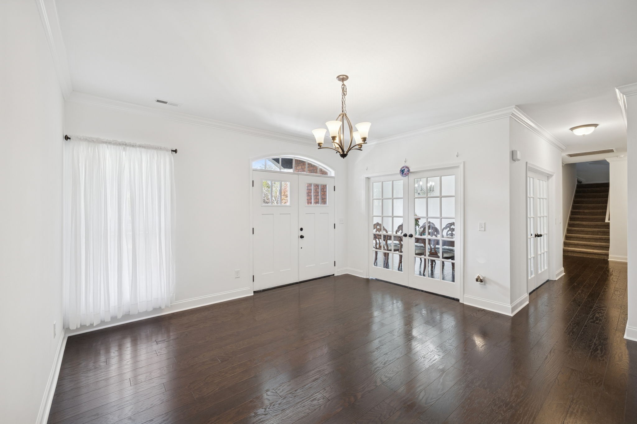 926 Monteagle Falls Road Monteagle, TN 37356 - Photo 5 of 30 an empty room with wooden floor chandelier and windows