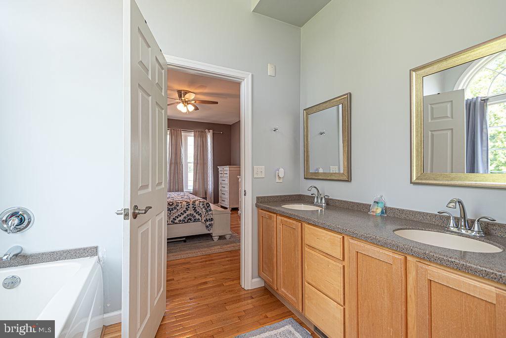 10671 Cathell Road Berlin, MD 21811 - Photo 25 of 63 a en suite bathroom with a granite countertop sink and a mirror