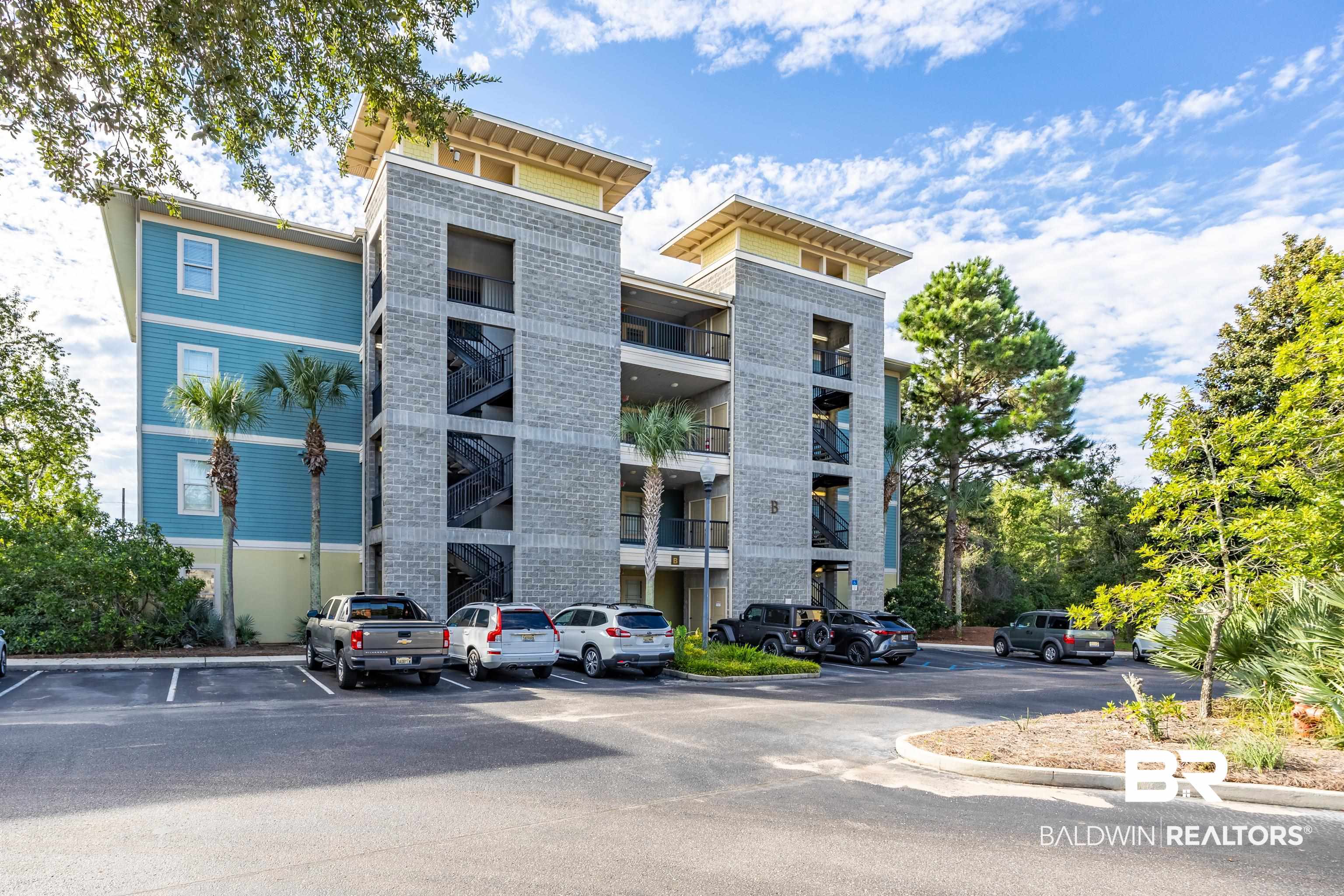 1430 Regency Road, Unit B201 Gulf Shores, AL 36542 - Photo 49 of 59 View of apartment building / complex with uncovered parking