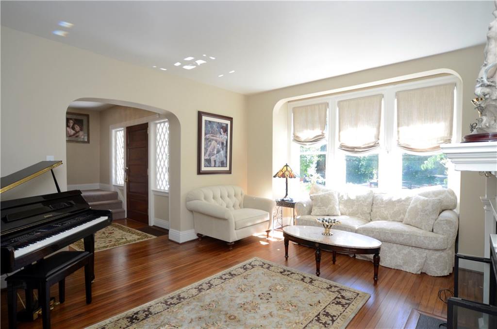 309 Quaker Road Sewickley, PA 15143 - Photo 4 of 25 The large living room with wood floors is flooded with natural light.