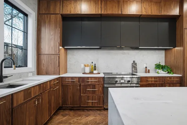 a kitchen with stainless steel appliances granite countertop wooden cabinets and a stove