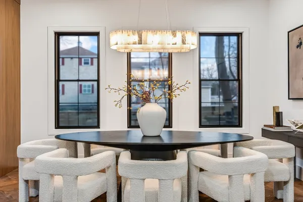 a view of a dining room with furniture and chandelier