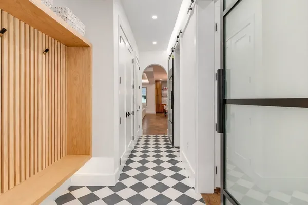 a view of a hallway with wooden floor and staircase