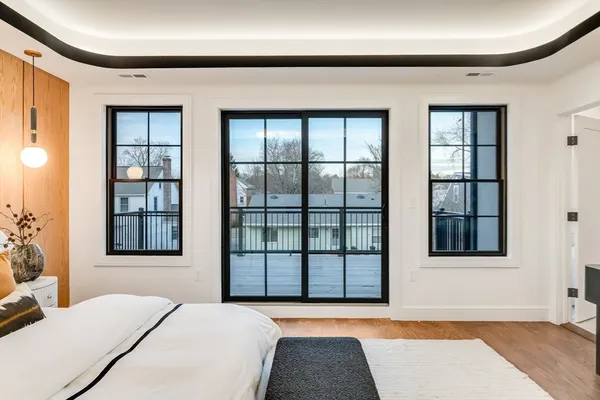 a bedroom with a bed and a large window