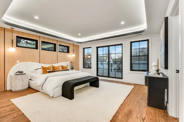 a bedroom with a large bed and a large window