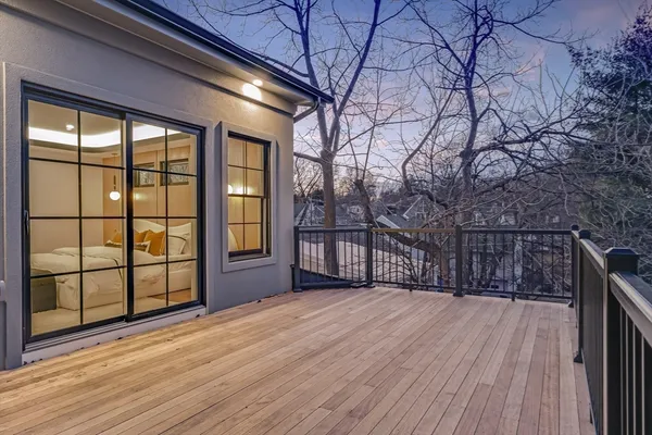 a view of backyard with large trees and wooden floor