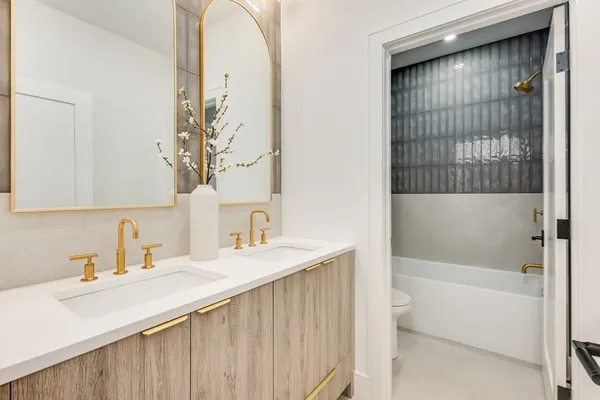 a bathroom with a sink a mirror and a bathtub