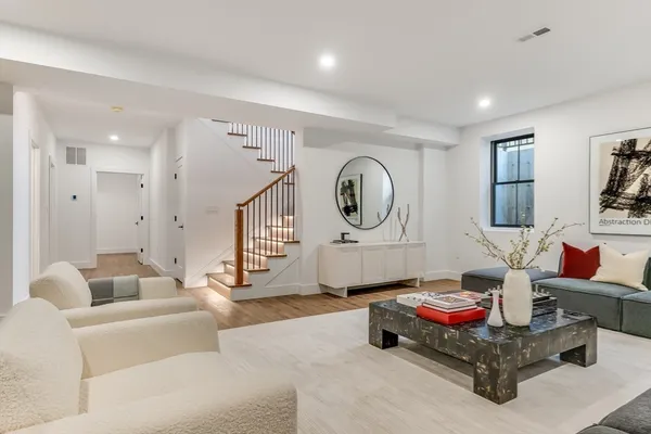 a living room with furniture and a clock