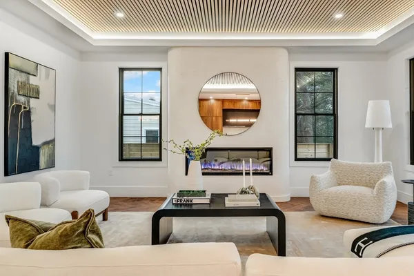 a living room with furniture and a large mirror