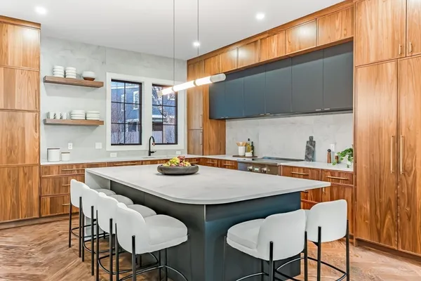 a kitchen with stainless steel appliances a sink and a refrigerator
