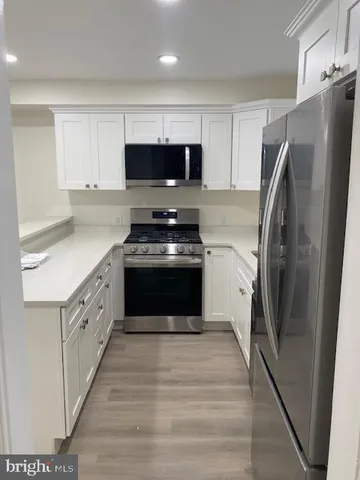 a kitchen with stainless steel appliances a refrigerator stove and sink