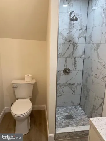 a bathroom with a toilet and a shower