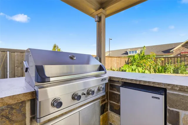 a stove top oven sitting inside of a kitchen