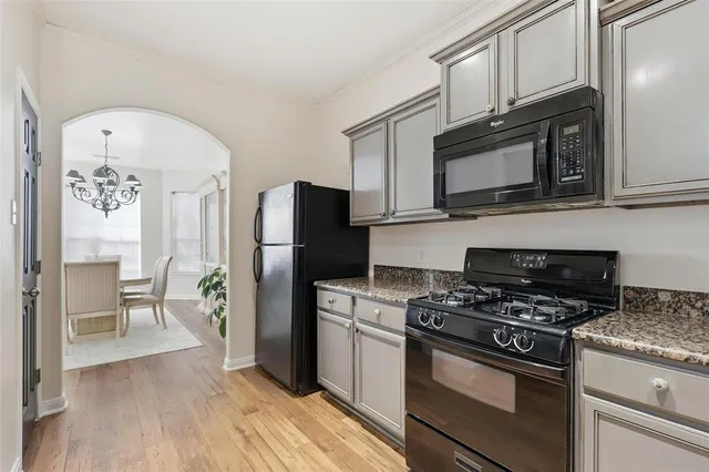 a kitchen with stainless steel appliances a stove microwave and a refrigerator
