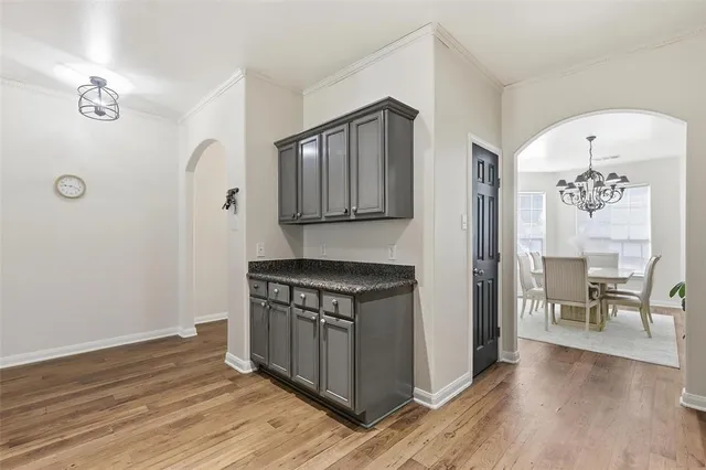 a kitchen with granite countertop a stove and a wooden floors