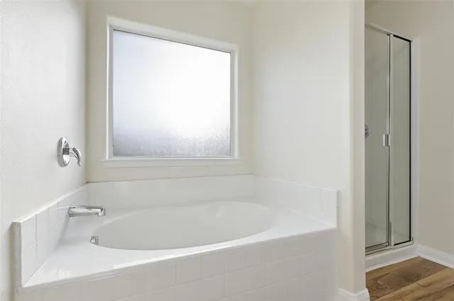 a white bath tub sitting next to a window
