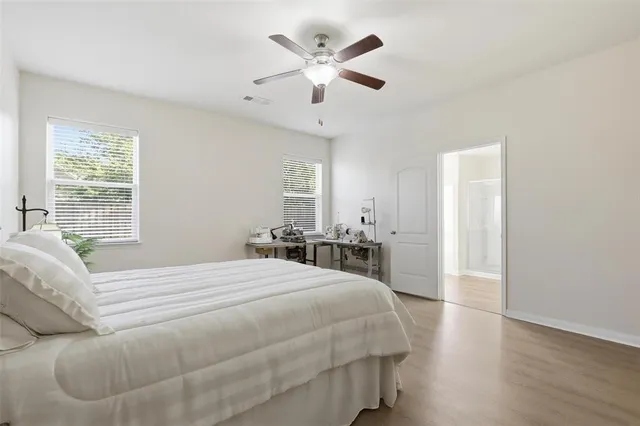 a spacious bedroom with a bed and a large window