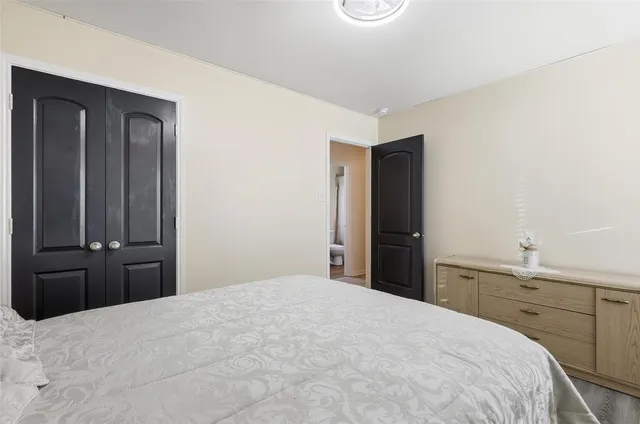 a bedroom with a bed and a dresser