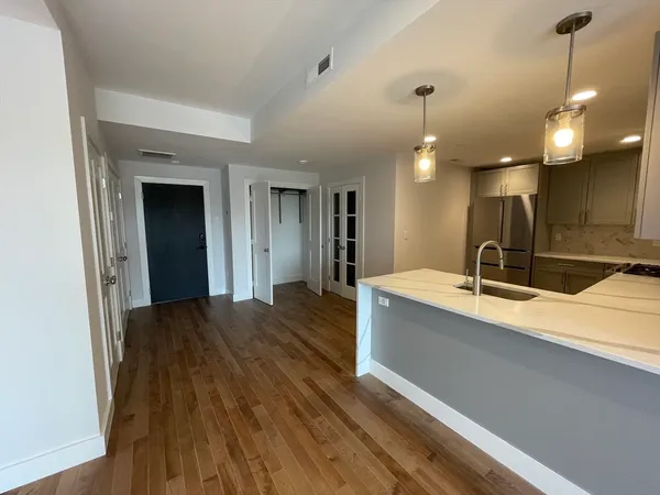 a spacious bathroom with a sink a large mirror and vanity