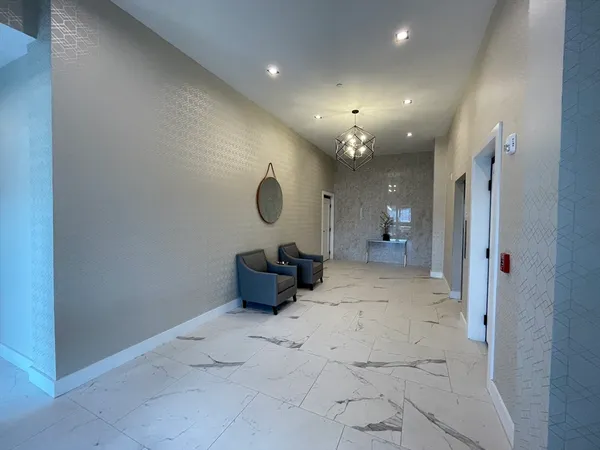 a view of a hallway with chandelier