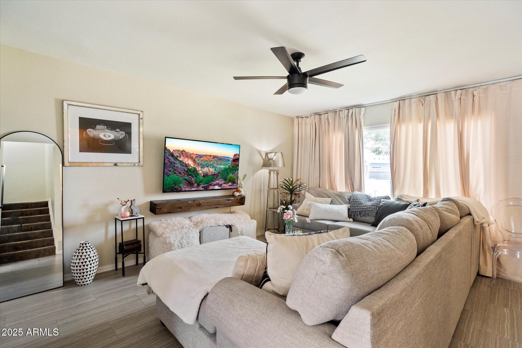 6005 North Granite Reef Road Scottsdale, AZ 85250 - Photo 1 of 19 a living room with furniture and a flat screen tv