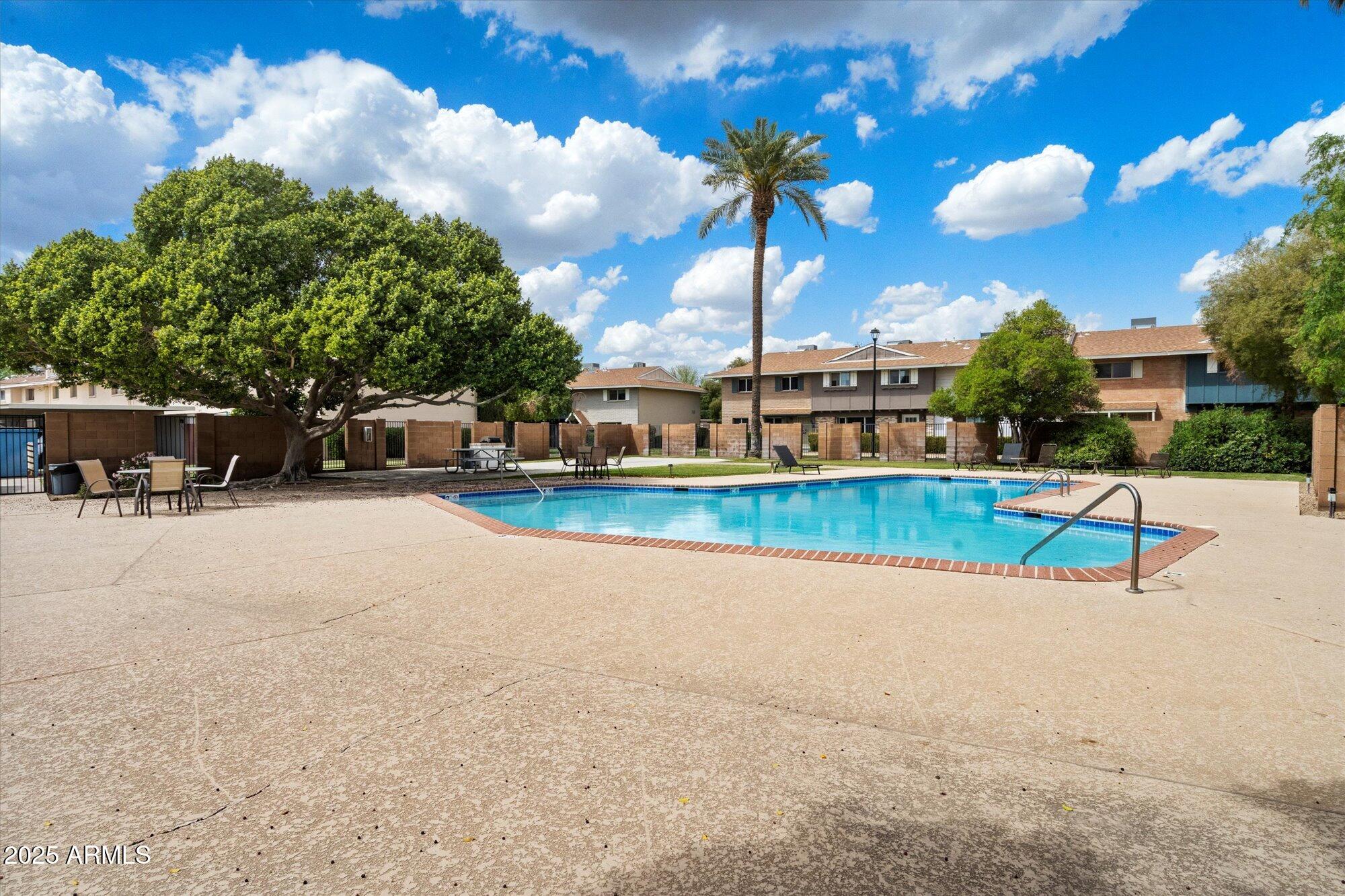 6005 North Granite Reef Road Scottsdale, AZ 85250 - Photo 16 of 19 a view of a swimming pool with a yard