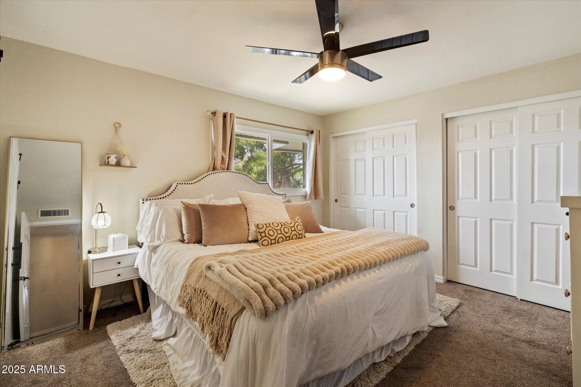 6005 North Granite Reef Road Scottsdale, AZ 85250 - Photo 6 of 19 a bedroom with a bed and a chandelier