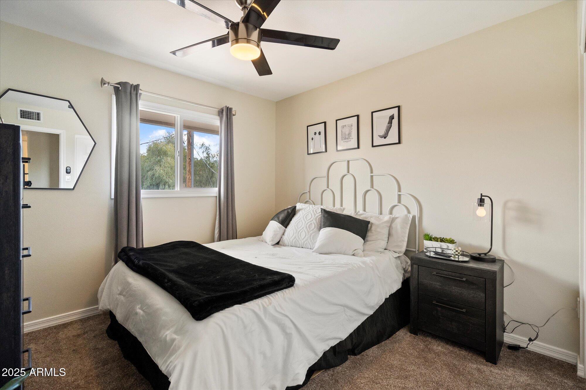 6005 North Granite Reef Road Scottsdale, AZ 85250 - Photo 9 of 19 a bedroom with a bed and a chandelier