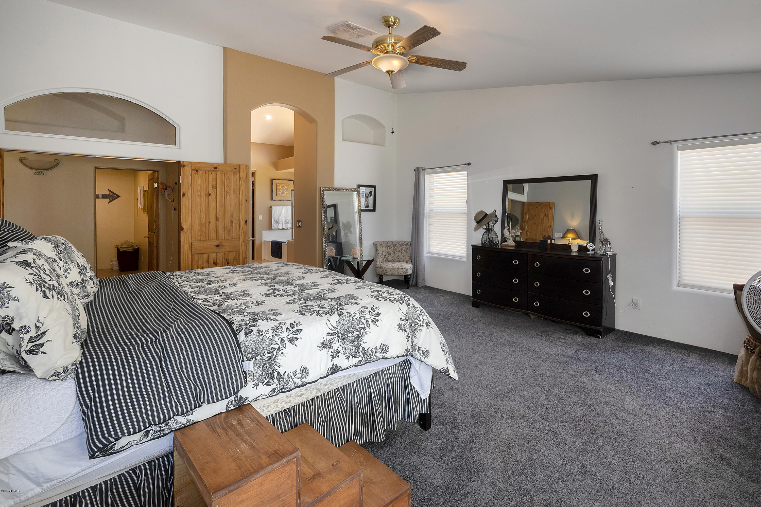 13849 East Hawknest Road Scottsdale, AZ 85262 - Photo 22 of 52 a spacious bedroom with a bed and dresser with mirror