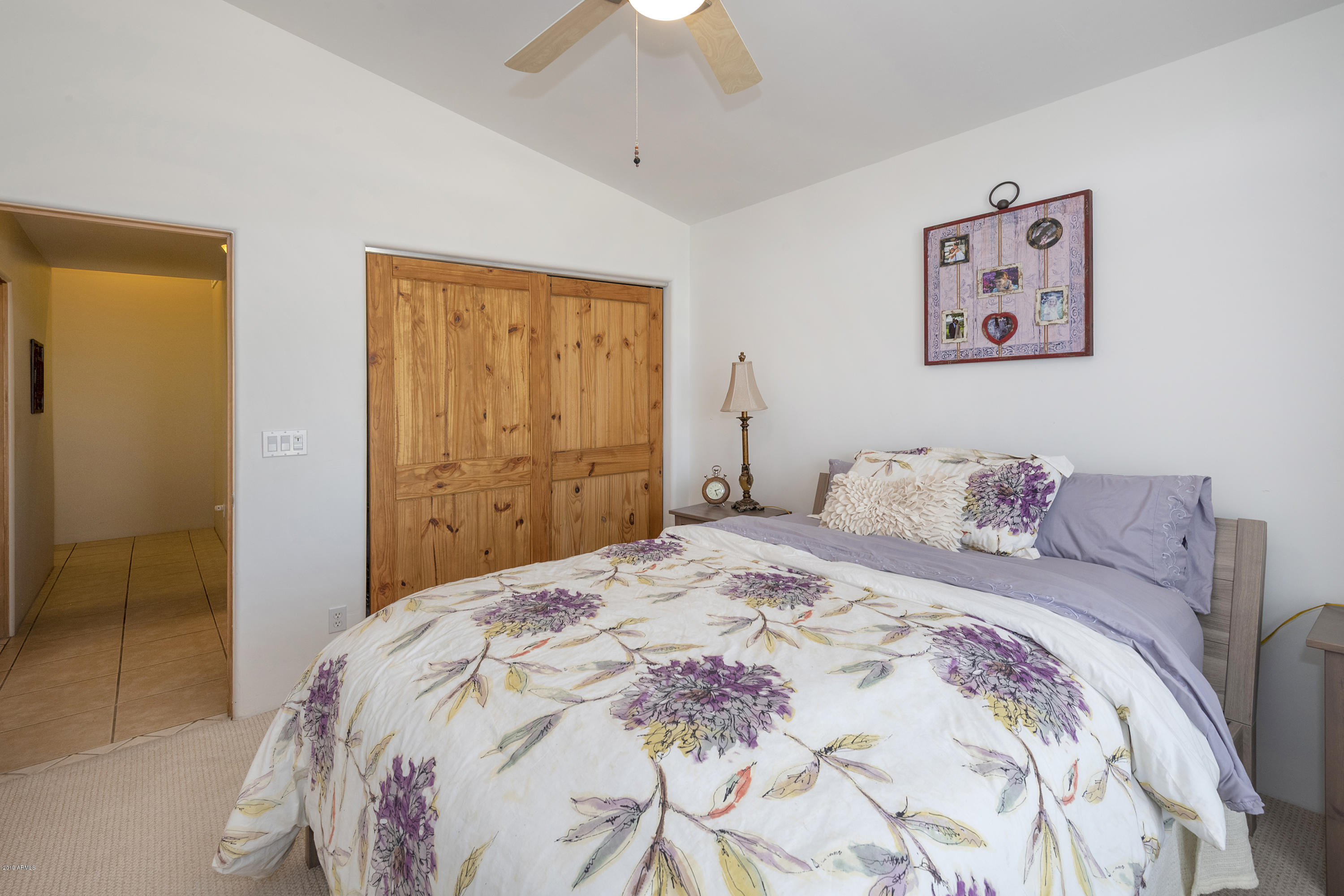 13849 East Hawknest Road Scottsdale, AZ 85262 - Photo 26 of 52 a bedroom with a large bed and a chandelier